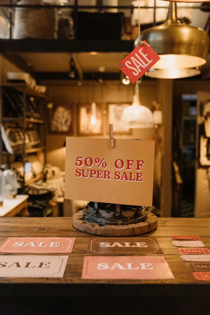 Printed sale sign before changing text in the image: “50% OFF” → “70% OFF”
